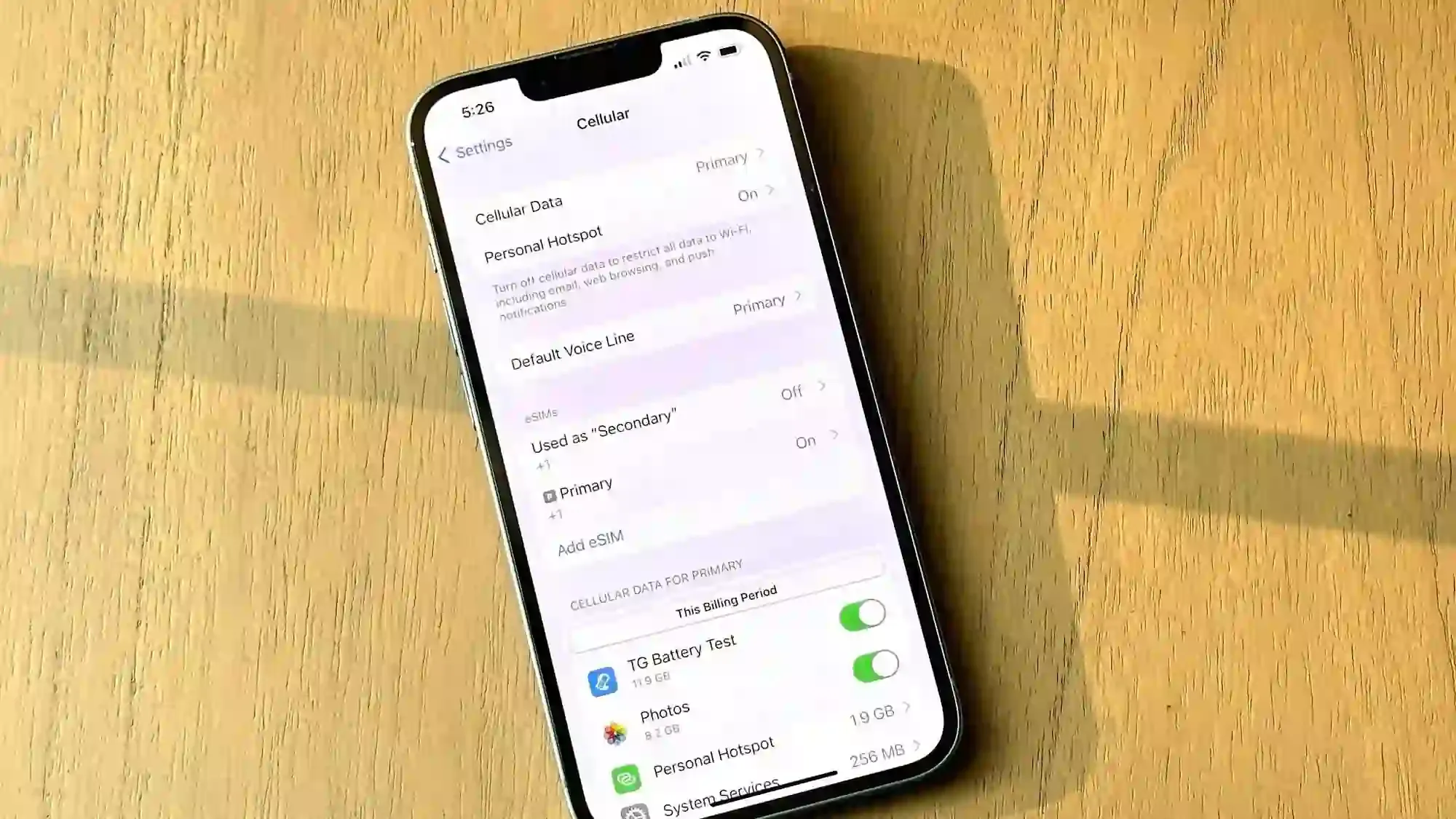 iPhone displaying cellular settings with eSIM options, illustrating how to configure iMessage while using a travel eSIM.