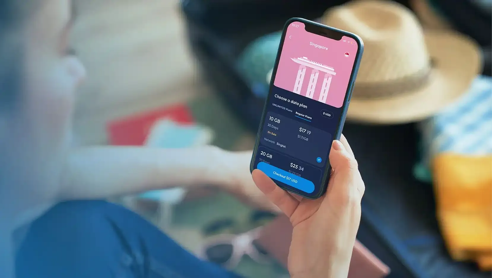 Traveler using Nomad app to buy a Singapore eSIM data plan.
