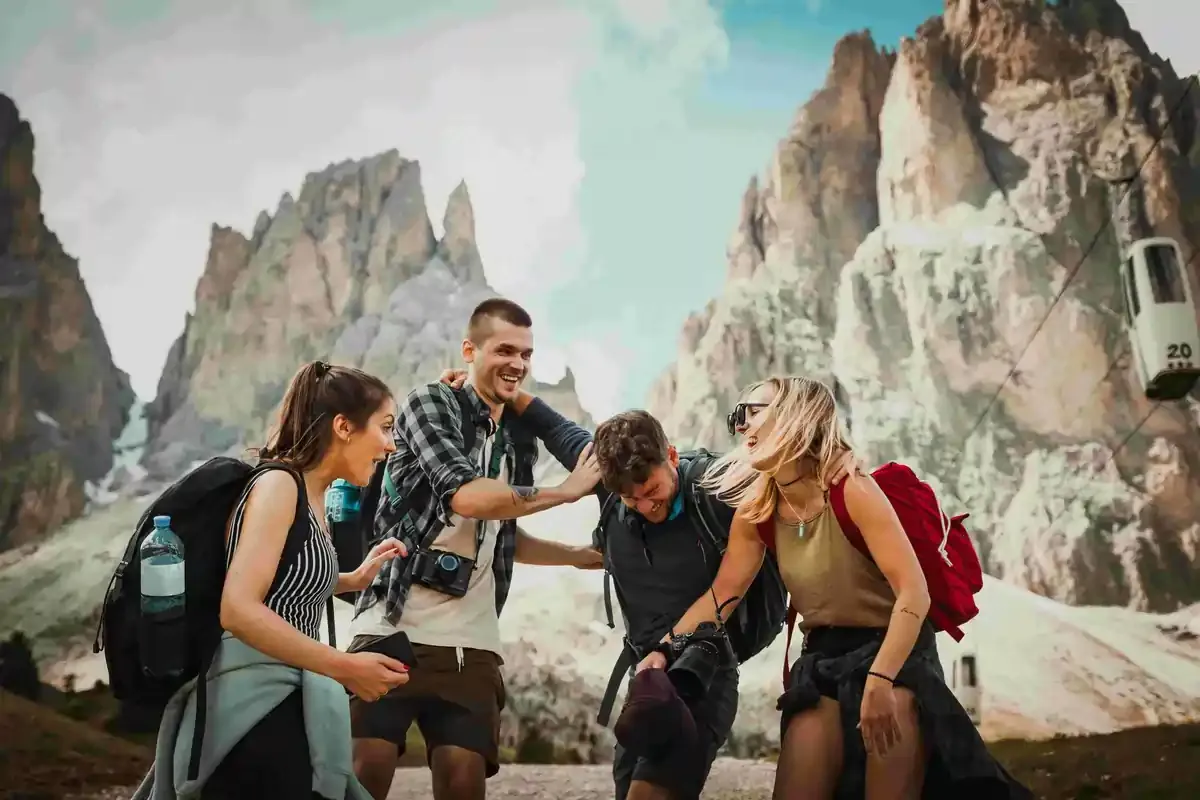 Group of happy hikers in the mountains with backpacks and cable cars, exploring lesser-known Easter holiday destinations in Europe