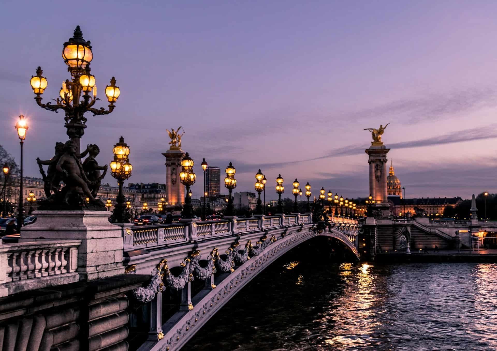 Pont Alexandre III bridge in Paris over the Seine River at sunset