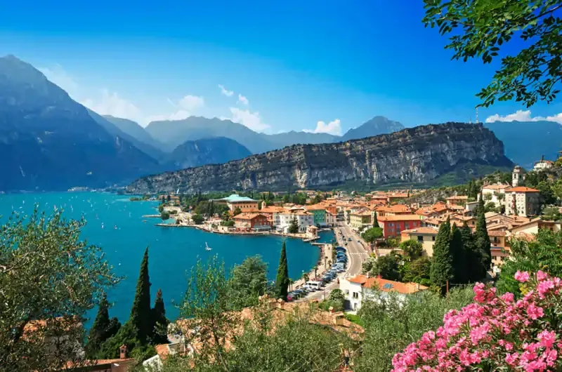 Lakefront town with mountains backdrop