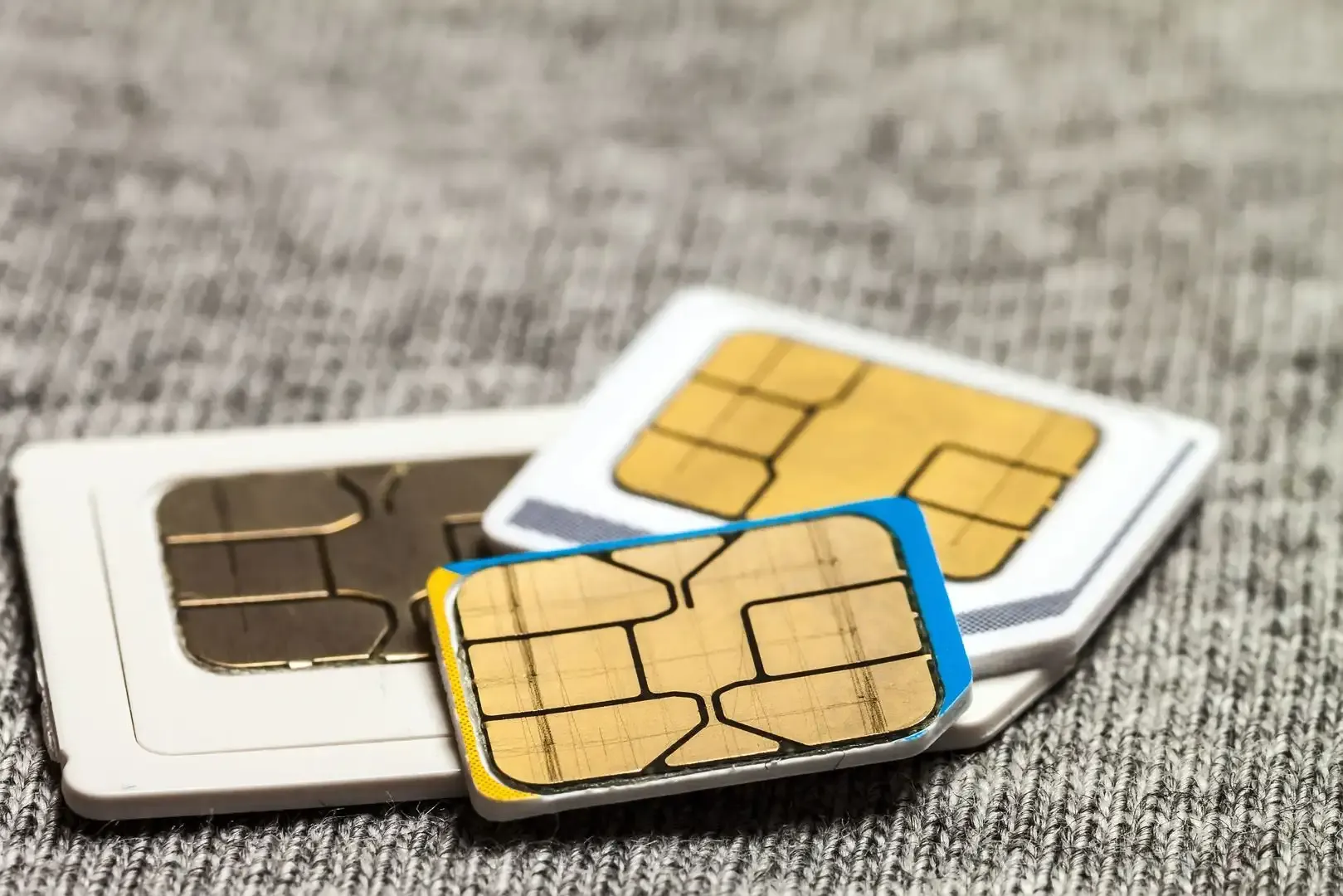 Close-up of three SIM cards illustrating the physical condition of SIM cards.