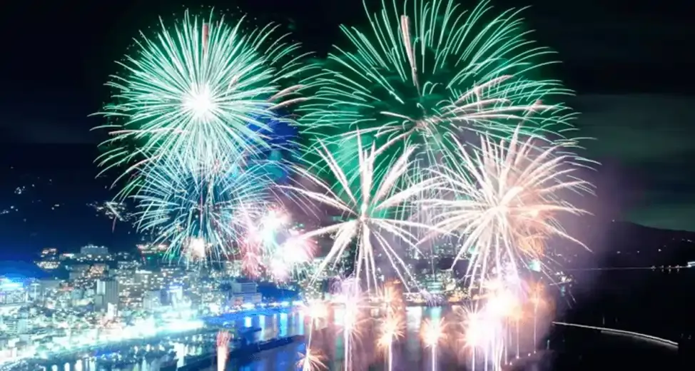 Colorful fireworks over Atami city at night.