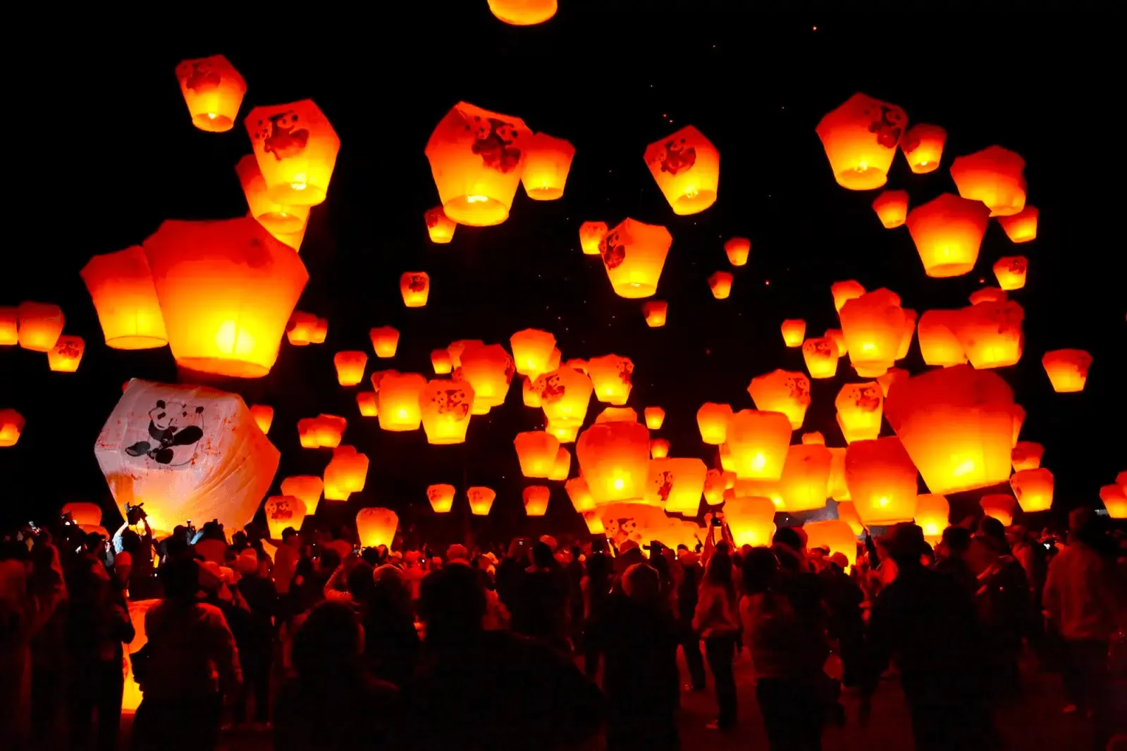 Sky lanterns illuminating the night sky at the Pingxi Lantern Festival in Taiwan