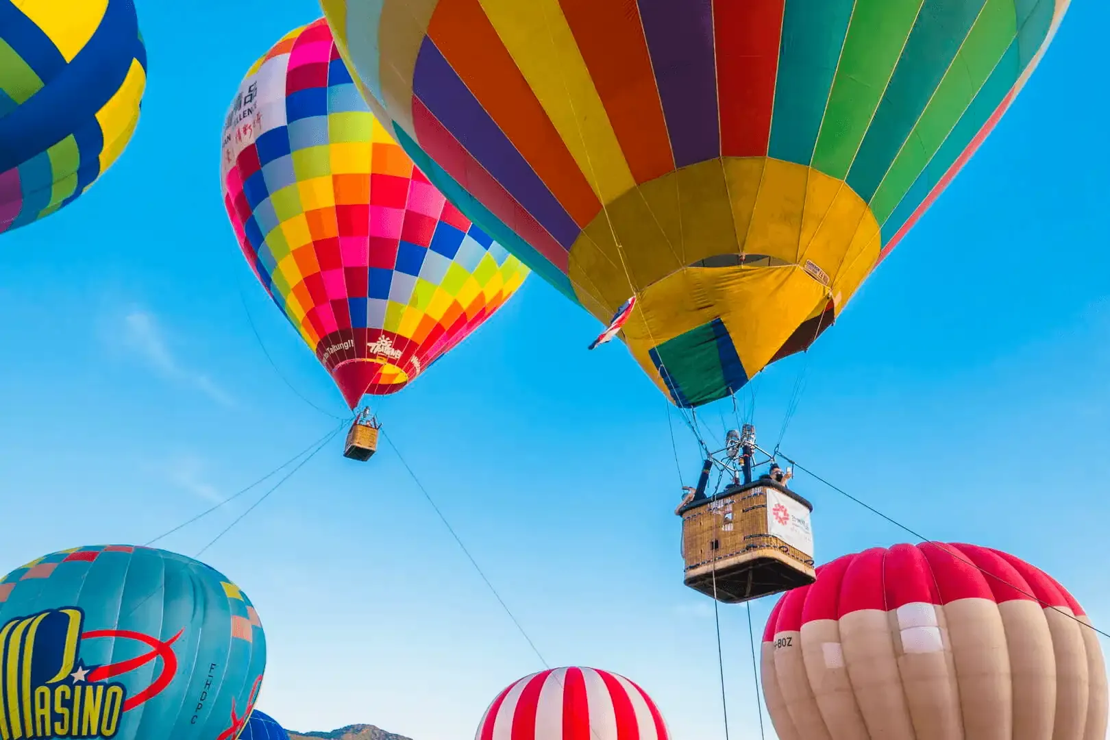 Close-up view of colorful hot air balloons ascending into the blue sky at the Taiwan International Balloon Festival in Taitung.