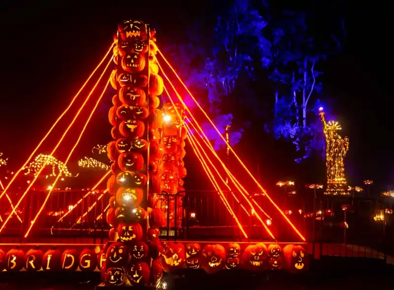 Pumpkin bridge and Statue of Liberty carved from jack-o’-lanterns at the Jack O’Lantern Blaze 2023 in New York.