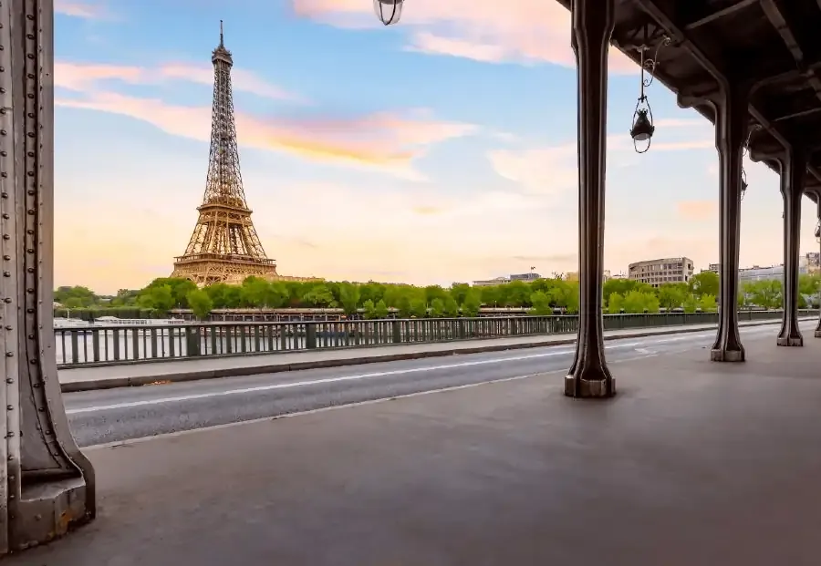 Eiffel Tower viewed from under Pont de Bir-Hakeim bridge at sunset in Paris, France