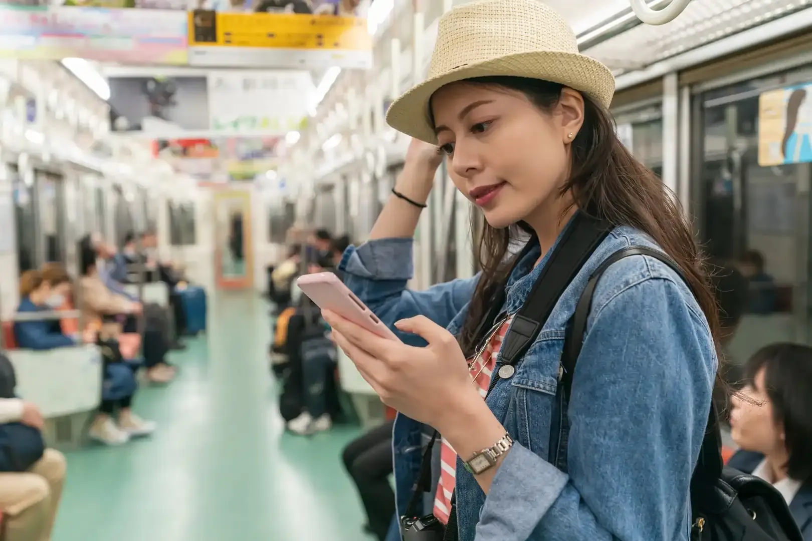 First-time traveller checking her route on her phone whilst in a subway in Japan.