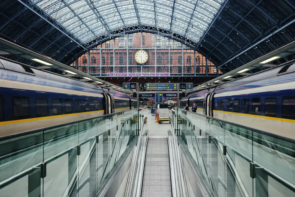High-speed trains waiting at a European railway station platform.