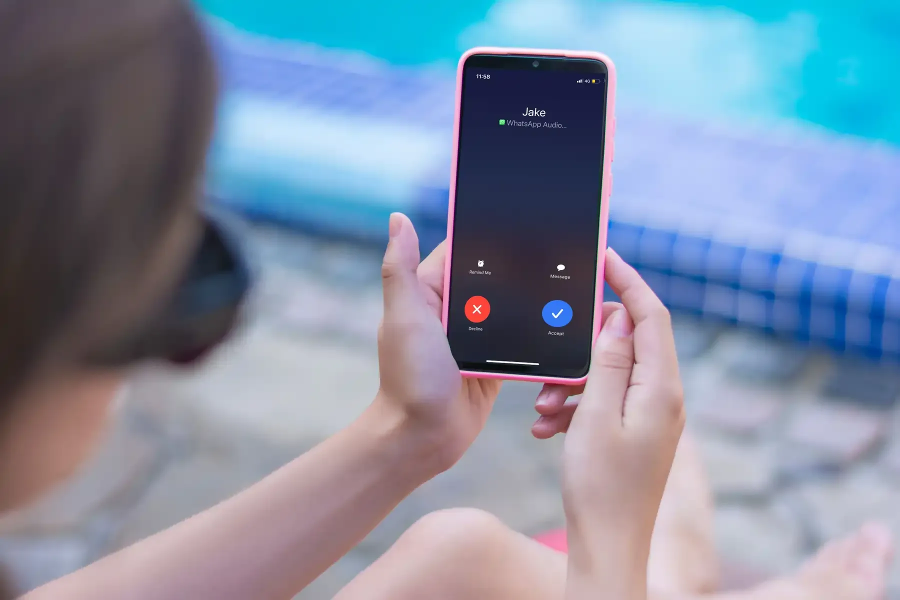 Woman receiving WhatsApp audio call on smartphone while abroad.