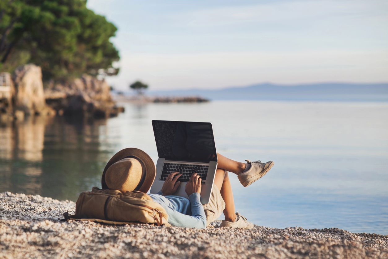 Guy with Laptop by the Beach