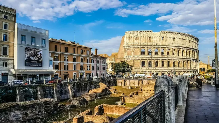 View of the Colosseum and surrounding streets in Rome, Italy, on a sunny day – a key attraction for travelers planning to buy a SIM card in Italy.