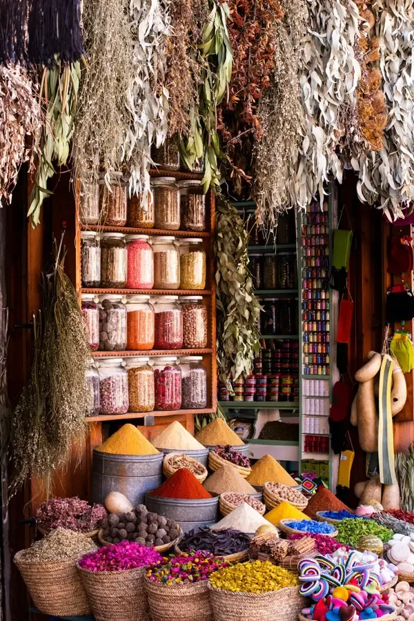 Colourful spices, dried herbs and flowers displayed at a traditional Moroccan market stall.