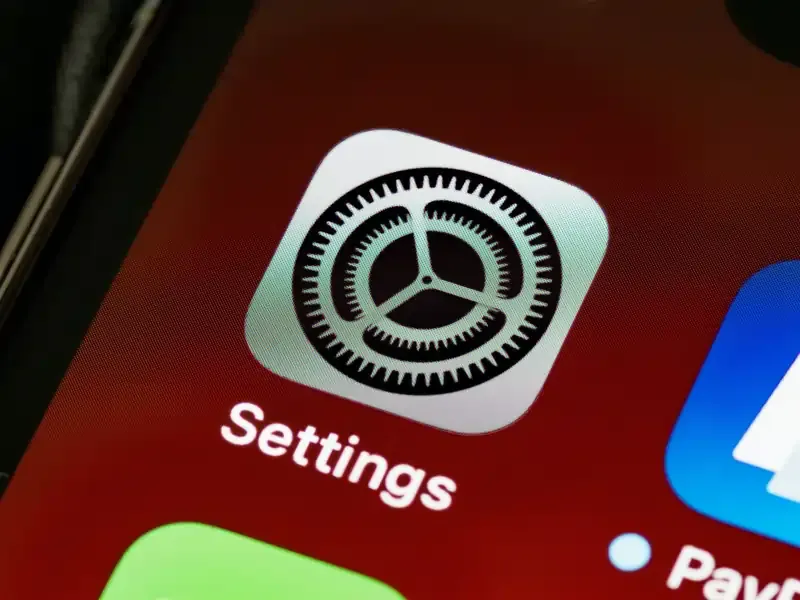 Close-up of iPhone Settings app icon used for fixing PDP authentication failure.