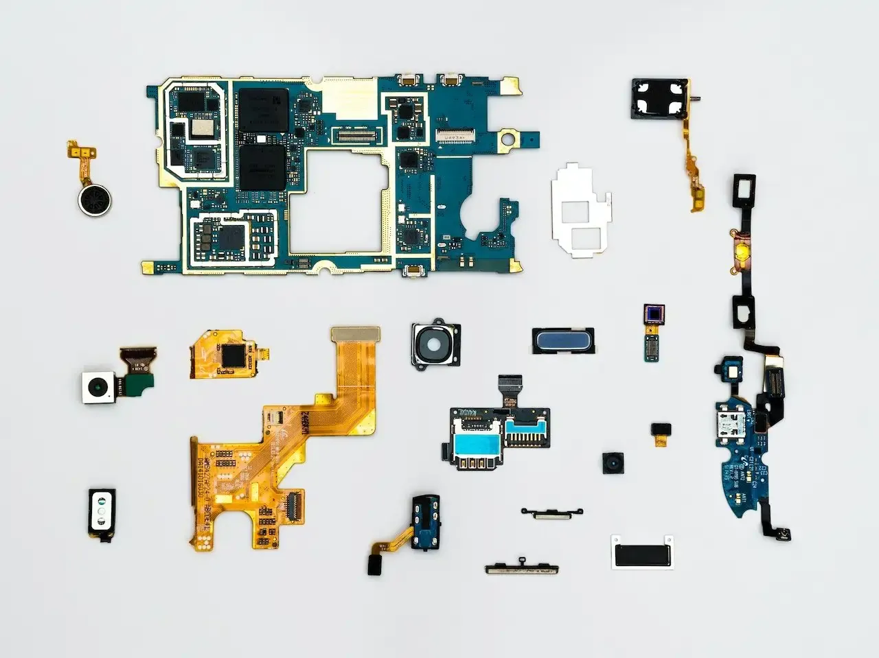 Disassembled smartphone with internal electronic components laid out.