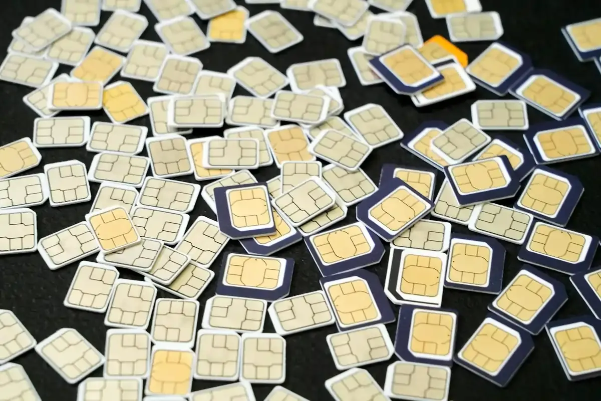 Multiple SIM cards scattered on a black surface