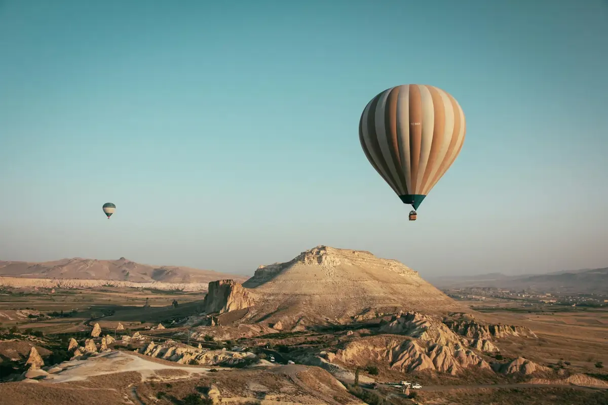 Hot air balloons soaring over Cappadocia’s unique rock formations at sunrise