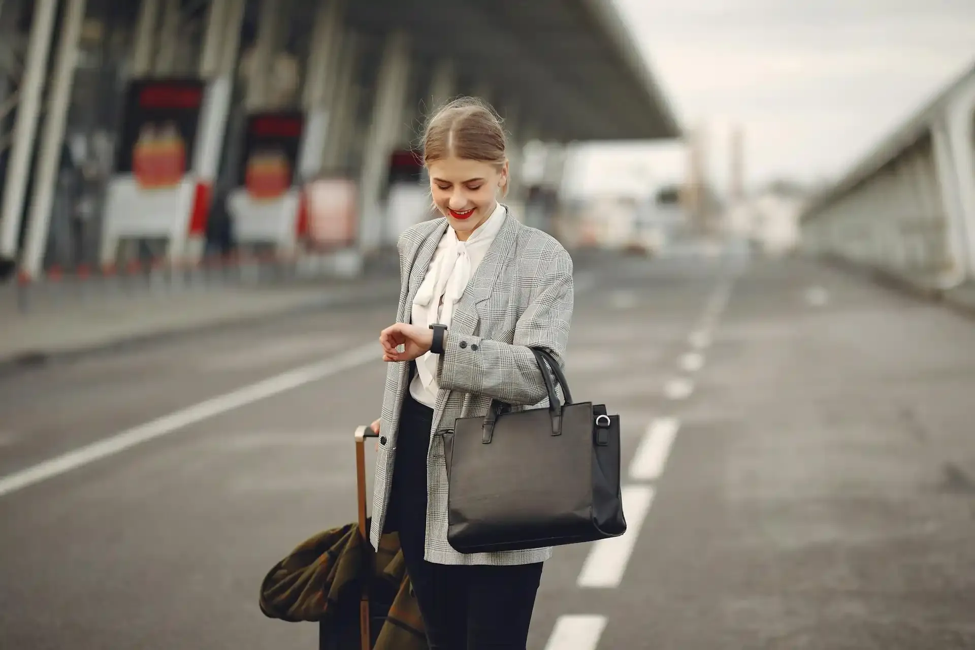 Business traveler with suitcase checking smartwatch outside airport, highlighting eSIM convenience for work trips.