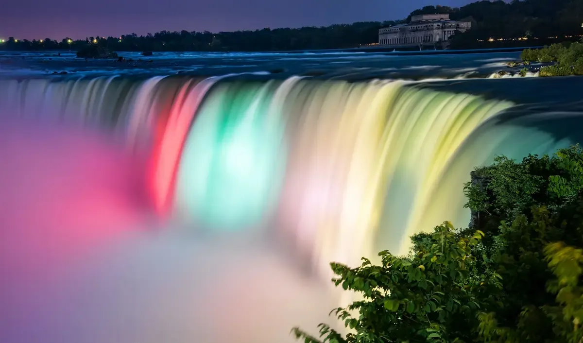 Niagara Falls illuminated at night with vibrant colors, a top attraction in Canada 