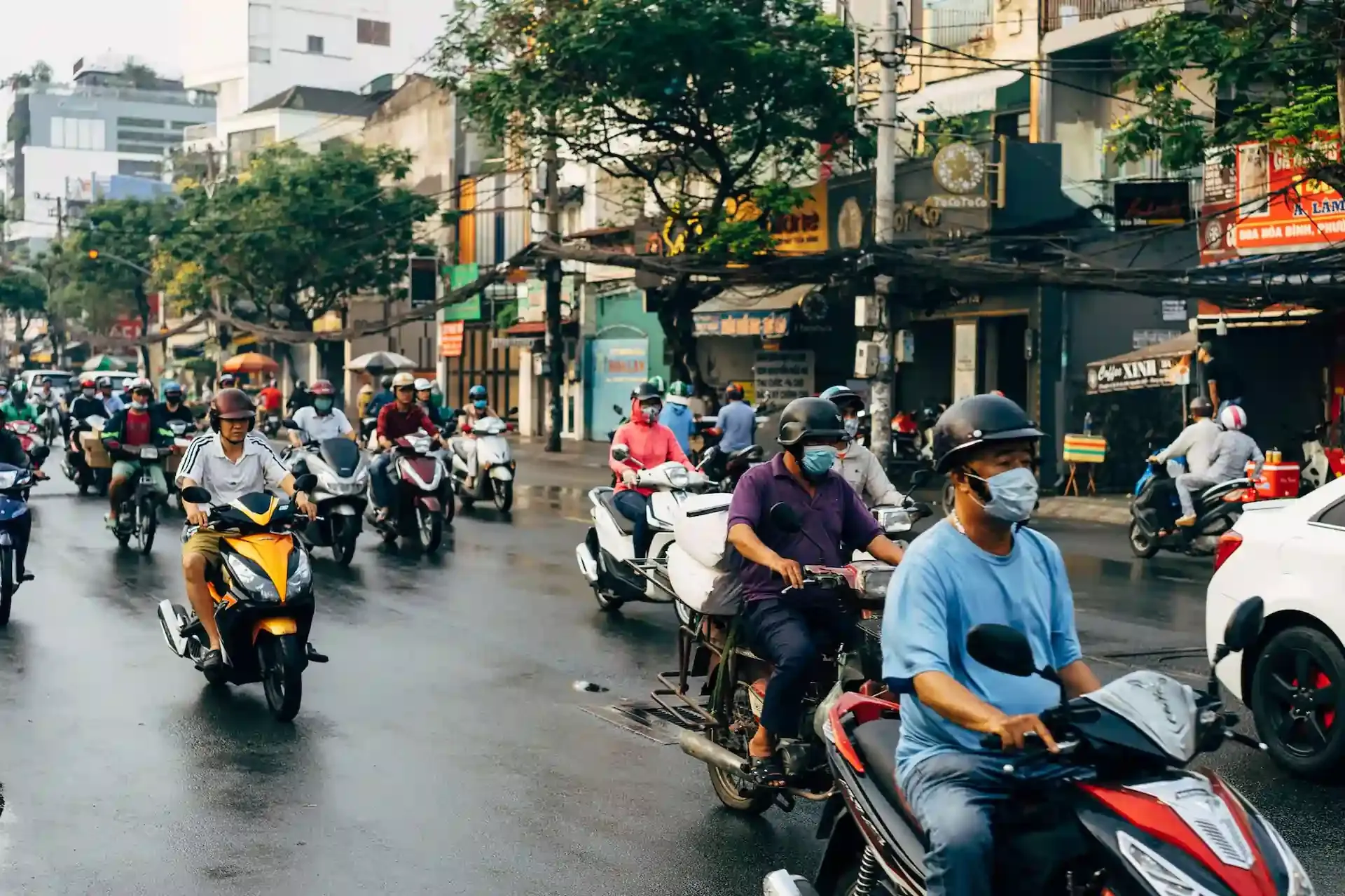 Busy street in Vietnam with people riding motorbikes, illustrating the need for reliable local eSIMs to stay connected while navigating urban life.