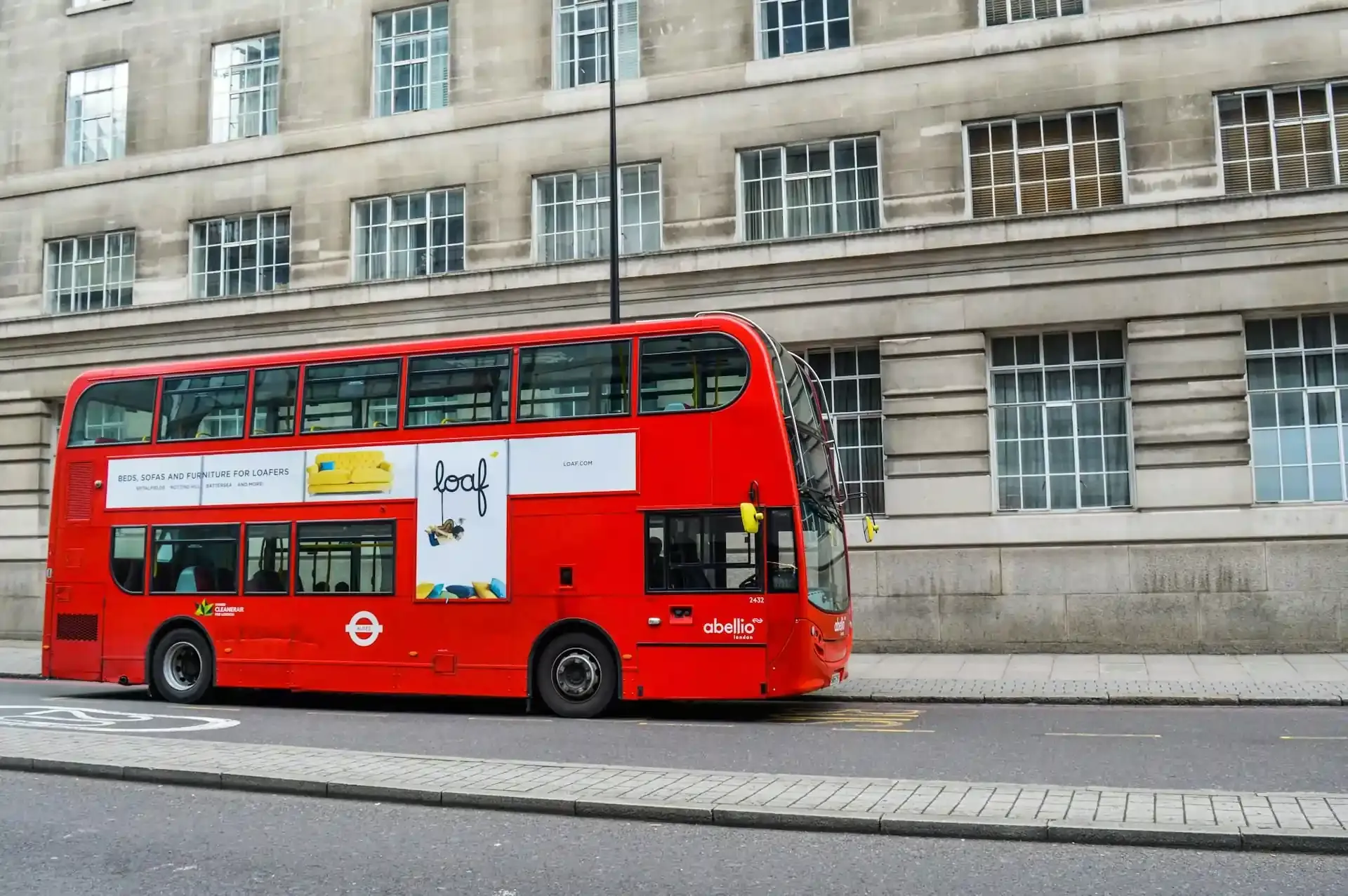 A classic red double-decker bus on a street in London, representing public transport in a major European city. Using transport apps can make navigating cities like London simple and efficient.