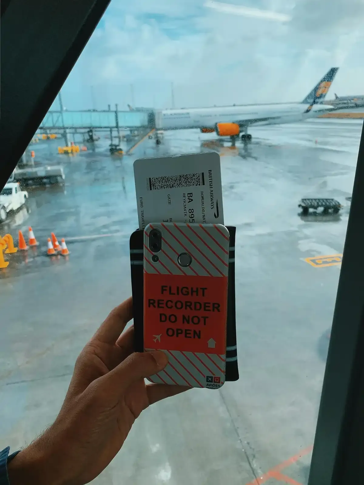 Hand holding boarding pass and phone at airport gate, debunking air ticket myths