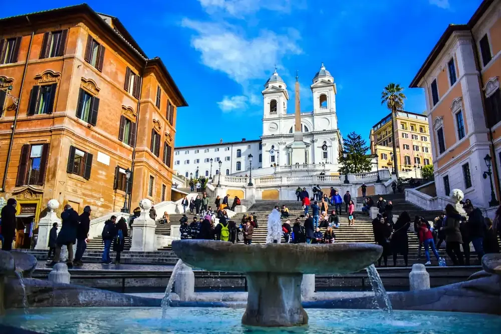 Tourists at the Spanish Steps and Fontana della Barcaccia in Rome, Italy. Popular European travel destination for culture, architecture, and romantic getaways