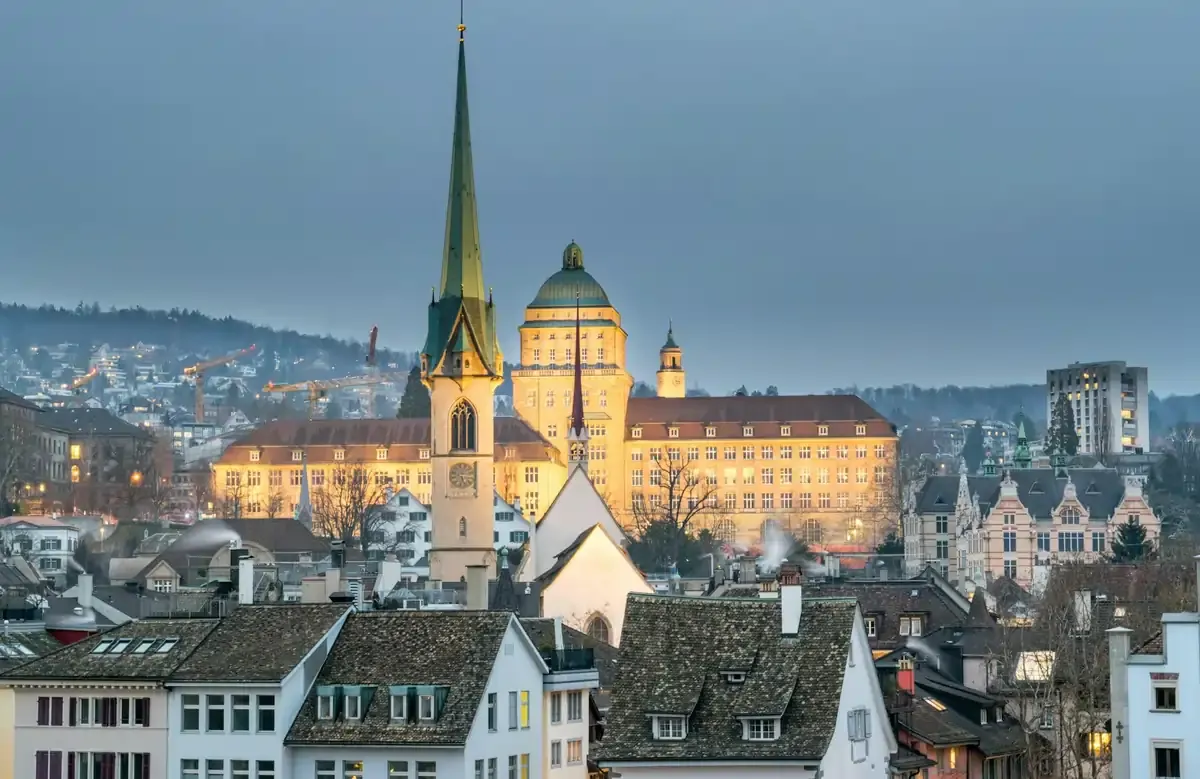 Scenic view of Zurich city skyline at dusk featuring historic buildings and church spires — essential travel tips for getting a SIM card in Zurich