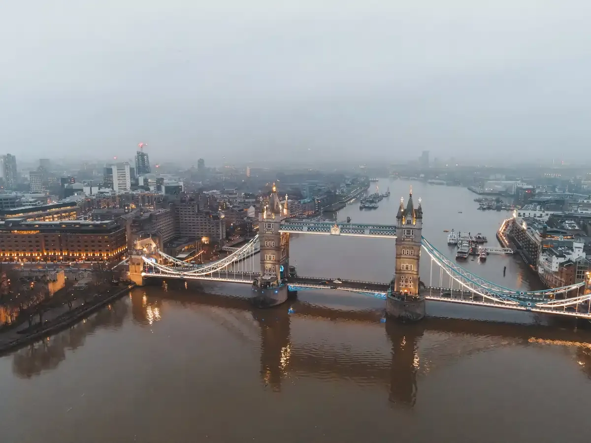 Aerial view of Tower Bridge and the River Thames in London on a foggy evening, iconic UK travel landmark and major European destination for tourists