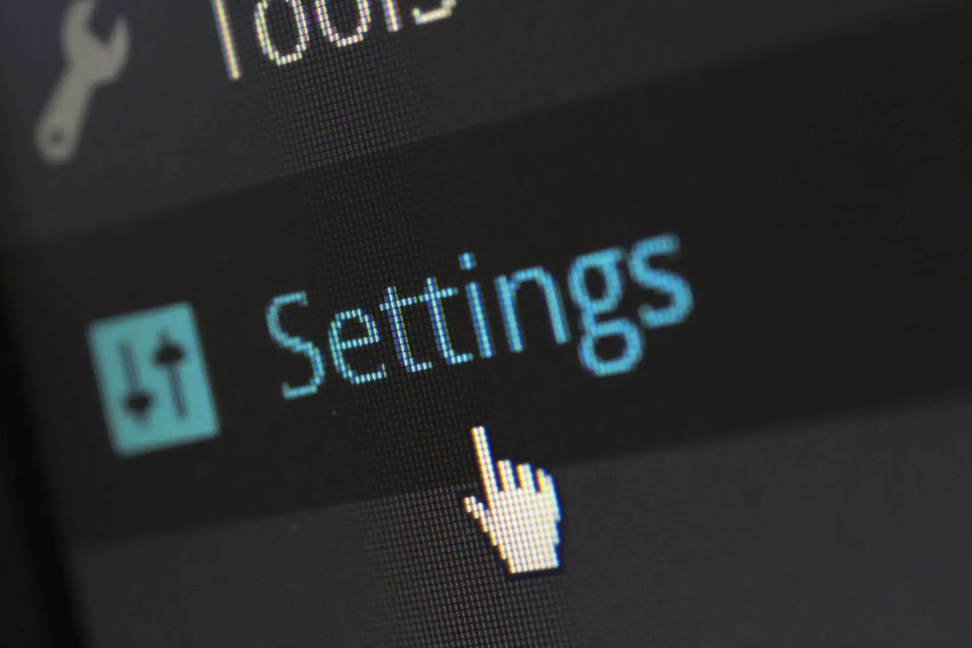 Close-up of a computer screen with a cursor pointing to the 'Settings' menu, representing the process of checking and configuring eSIM settings.