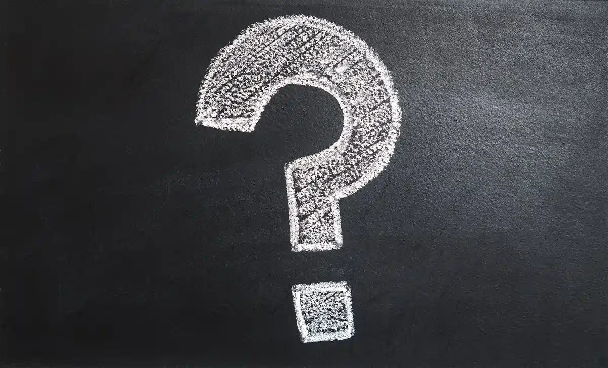 eSIM questions and answers concept illustrated by a chalk question mark on blackboard.
