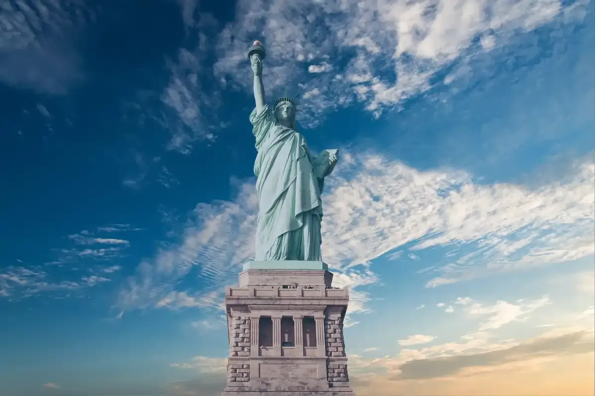 Statue of Liberty against blue sky at sunset. Iconic New York landmark and a must-visit US travel destination.