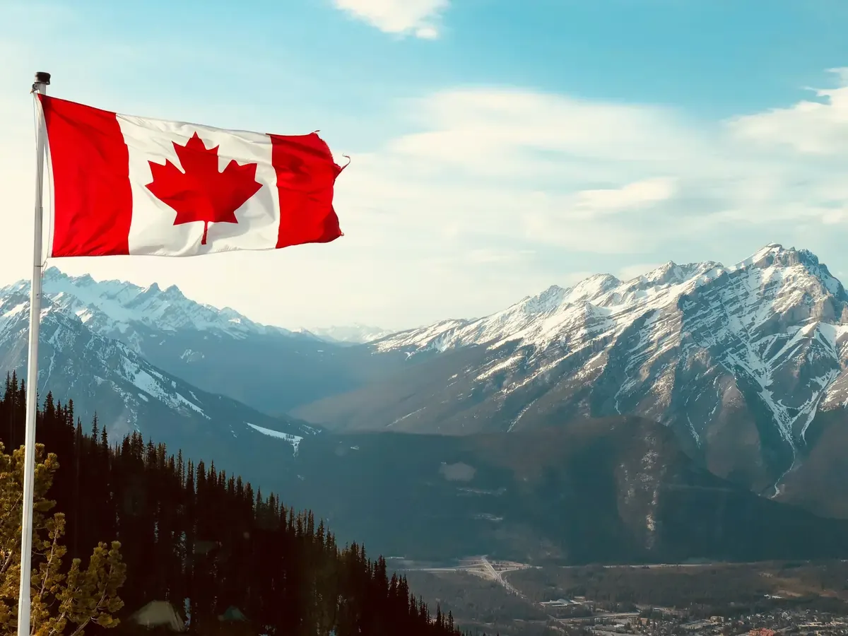 Canada flag overlooking Canadian rockies