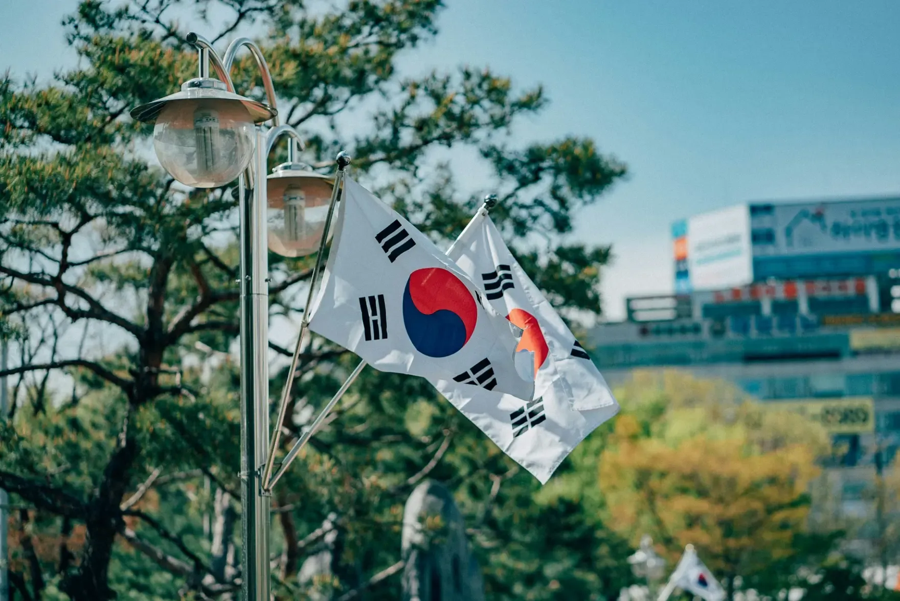 South Korean flags flying beside a street lamp in Seoul