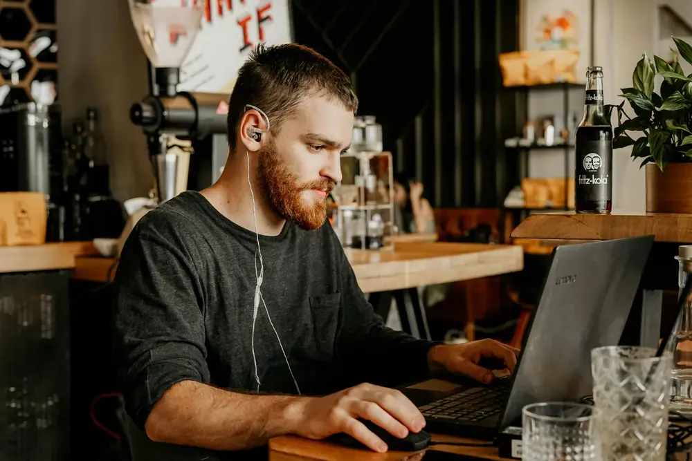 Digital nomad working remotely in a cafe